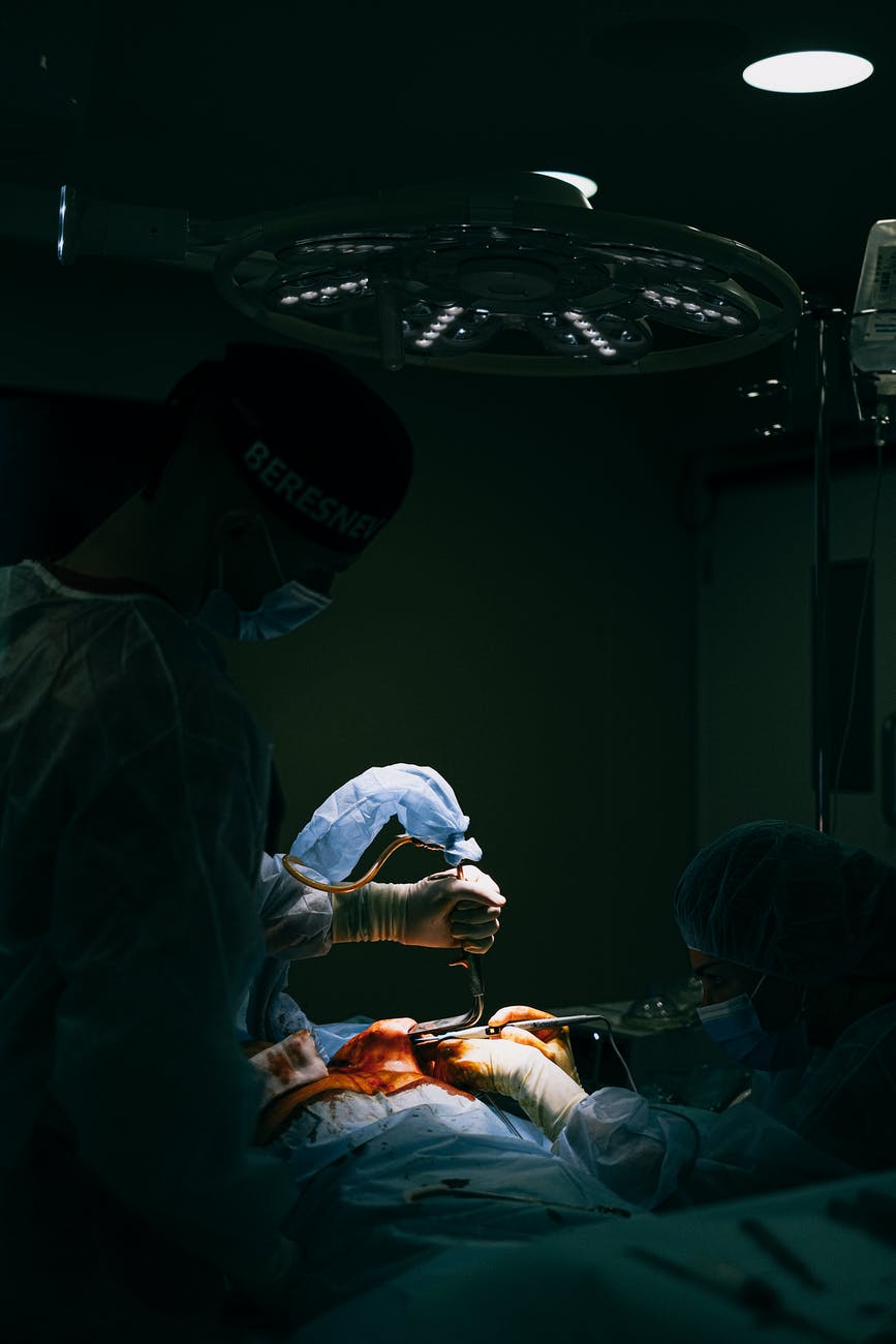 a surgeon operating a patient in the operating room